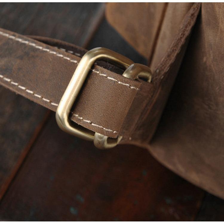 Close up shot of leather strap and brass buckle on Acadia leather backpack