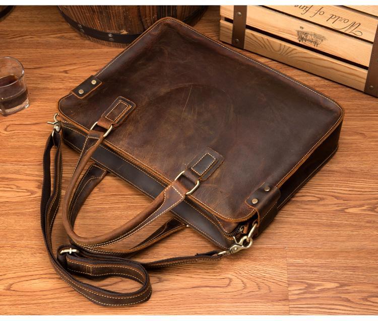 Bryce dark brown leather briefcase laying on its side showing leather handle and leather shoulder strap