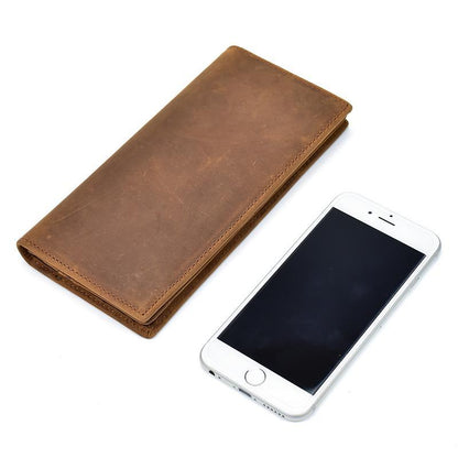 Bi Fold card holder men's wallet closed and showing an iPhone next to it. 