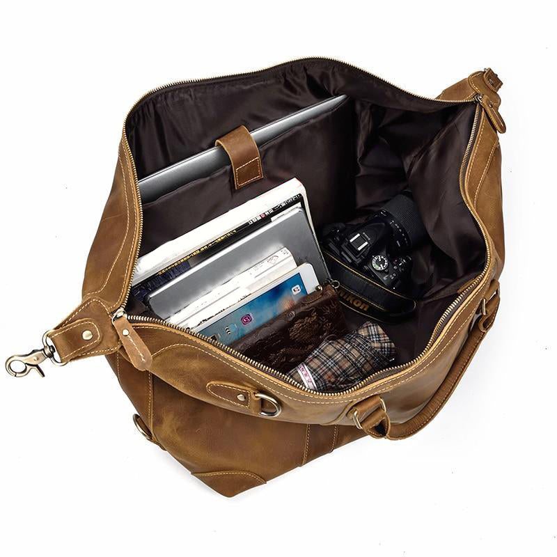 Leather Dayton Duffle and Overnight bag, open showing contents of camera, umbrella, laptop computer, and a few books