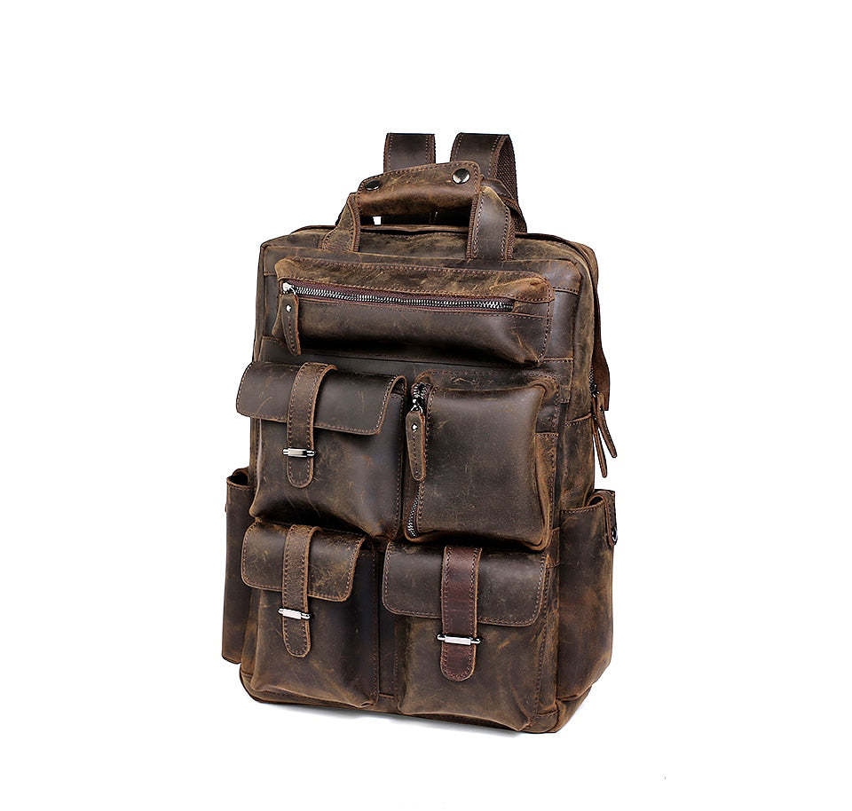 Dark Brown leacther back pack and camera case upright showing many large pockets for storing camera equipment or personal belongings