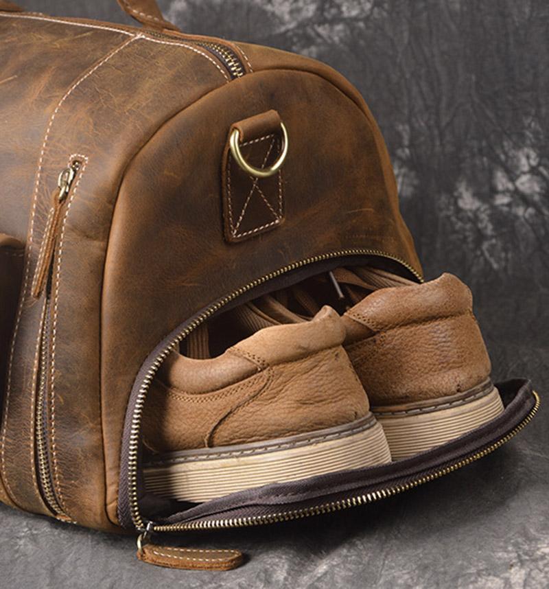 Pullman all leather duffle bag showing the end of bag as a shoe compartment and showing a pair of leather shoes sticking out of the bag