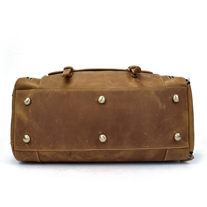 Bottom view of Pullman leather duffle bag showing brass bottoms to avoid scraping on ground