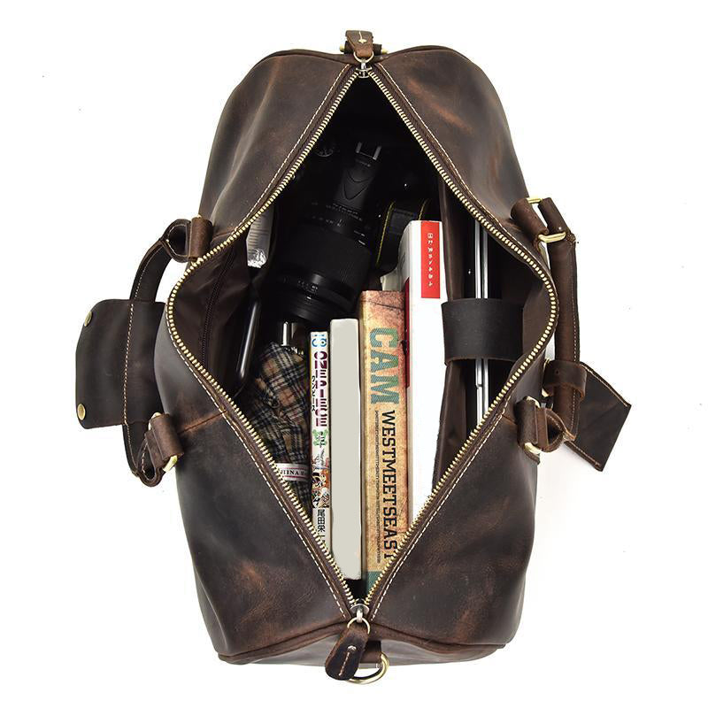 Dark brown men and ladies Redwood weekend or overnight duffle bag open showing contents of books and an umbrella