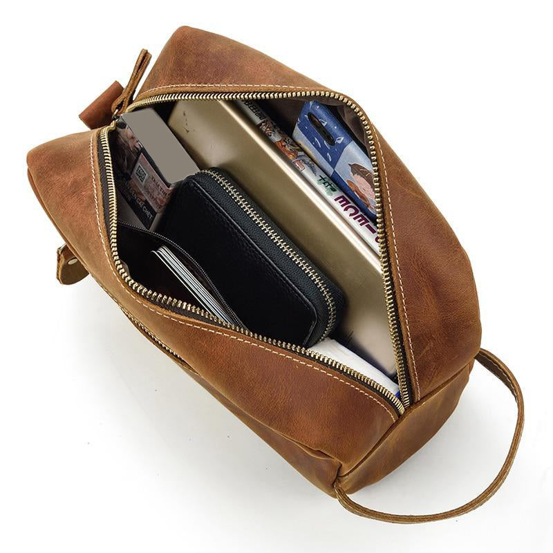 Rio Toiletry bag Dopp kit open to show contents of phone, books, wallet and other men's personal care items