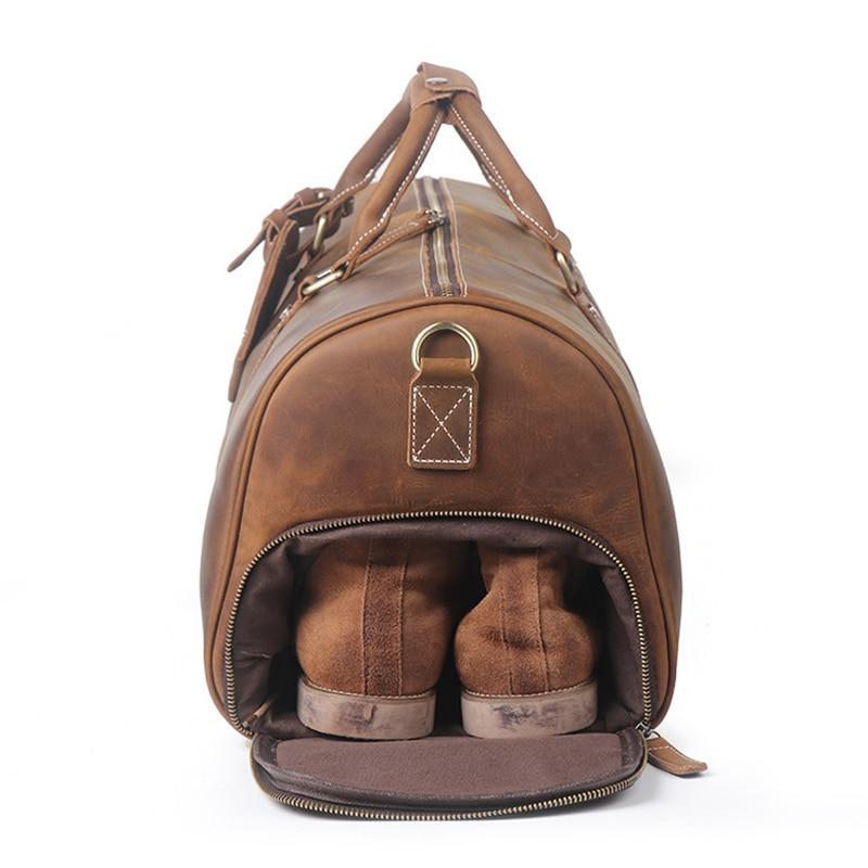 Rushmore duffle bag for women and men side view showing show compartment with tan shoes indie bag on white background 